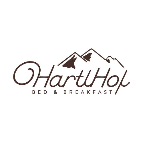 a logo for a bed and breakfast in the mountains at HartlHof in Proves