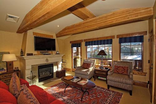 a living room with a red couch and a fireplace at The Chateaux Deer Valley in Park City