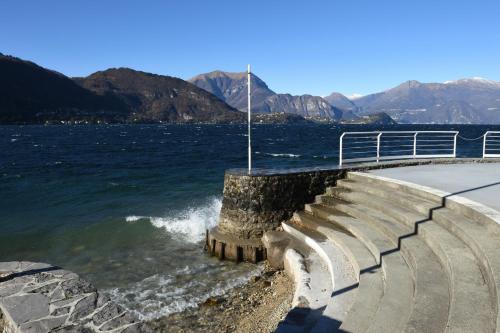 a set of stairs next to a body of water at Carpe Diem in Lierna