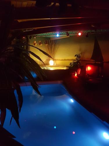 a view of a swimming pool at night with lights at Small resort Pini & SPA in Jūrmala