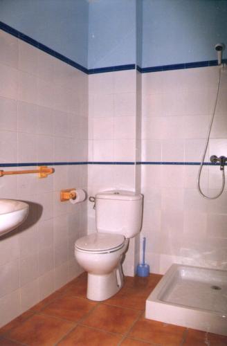 a bathroom with a toilet and a sink and a tub at Los Trulls d´Auligué in Pobla de Masaluca