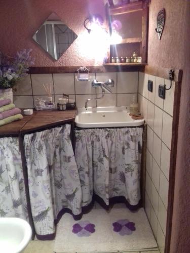 a small bathroom with a sink and a sink at CleMaison Antica Dimora Apartments CIR VDA GIGNOD 0013 in Gignod