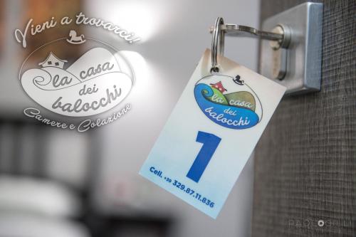 a sign on a door with a number one on it at La Casa dei Balocchi B&B in Toirano
