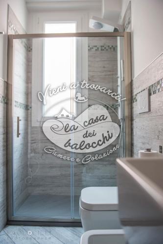 a bathroom with a shower with a toilet and a sink at La Casa dei Balocchi B&B in Toirano