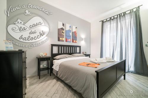 a bedroom with a bed and a coca cola sign at La Casa dei Balocchi B&B in Toirano