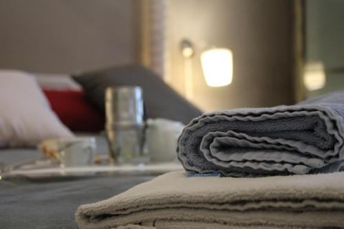 a pile of towels sitting on top of a bed at Al 68 Di Piazza Cavour in Naples