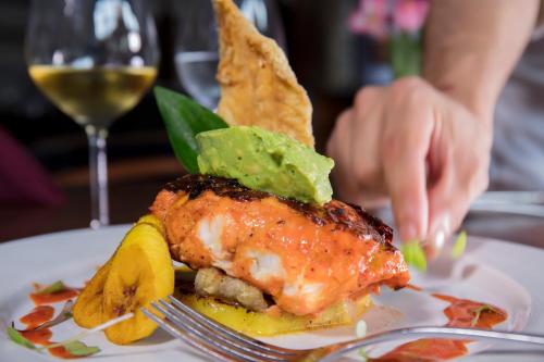 a plate of food with a piece of meat and a banana at Krystal Grand Nuevo Vallarta in Nuevo Vallarta 
