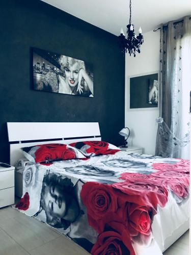 a bedroom with a large bed with red roses at La maison de Medea in Pulsano