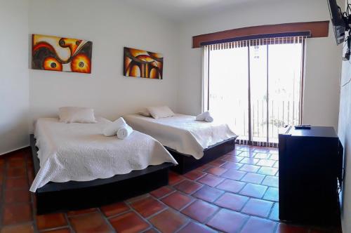Кровать или кровати в номере Jardín Cerritos Xochitepec