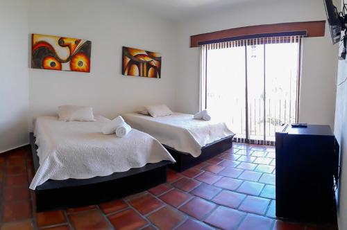 A bed or beds in a room at Jardín Cerritos Xochitepec