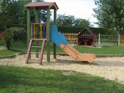 a playground with a slide in a park at la ferme des 4 chenes in Urt