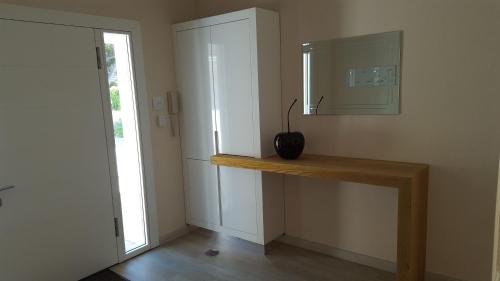 a bathroom with a counter with a mirror and a sink at Villa Karibu in Tokai
