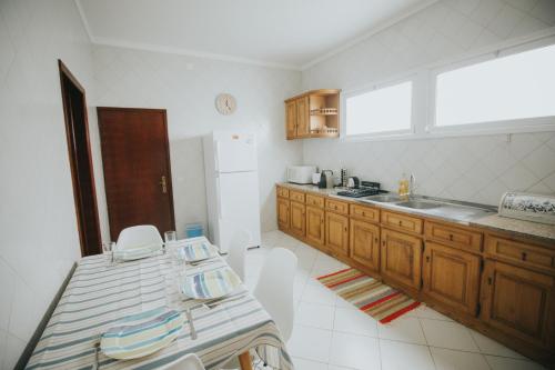 a kitchen with a table and a sink in it at Vila Luis Mendes in Ribeira Brava