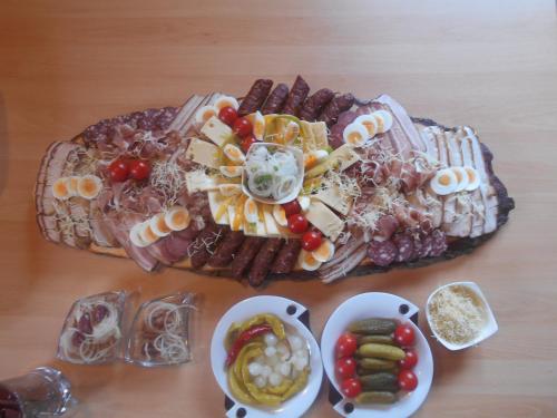a table topped with three plates of food with snacks at Apartment zum Wasserfall in Krakaudorf