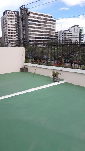 a green tennis court on top of a building at Hostal Santa María Gracia in Quito