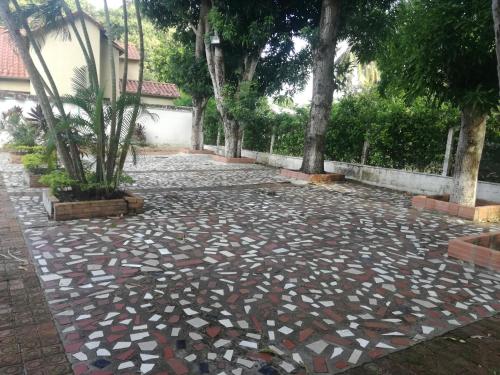 a stone walkway with trees in a courtyard at Casa Campestre Villa Margarita in Honda