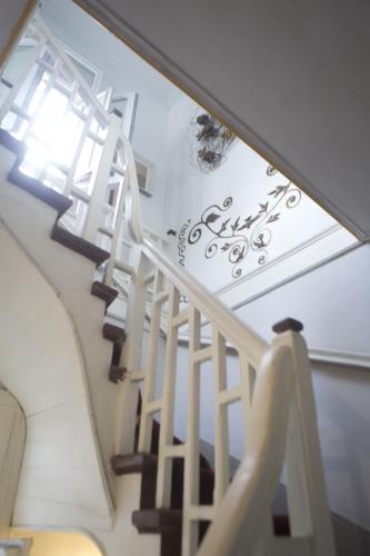 a staircase in a house with a white stair case at Casa Falleri Boutique Hotel in Lima