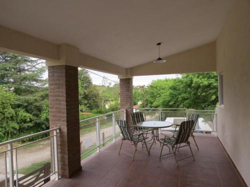 patio con mesa y sillas en el balcón en Casa en Villa Los Aromos en 