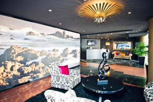 a living room with a large painting on the wall at Mercure Wellington Central City Hotel and Apartments in Wellington