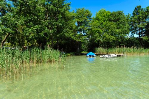 a boat in the middle of a lake at Hotel Haberl - Attersee in Attersee am Attersee