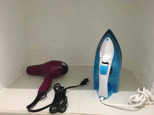 a hair dryer and a blow dryer with a hair dryer at Cancun Plaza - Best Beach in Cancún