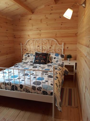 a bedroom with a bed in a log cabin at Cyprus Glamping Park in Ayios Theodhoros