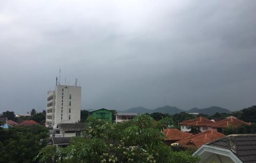 a view of a city with houses and a tall building at H12, The Stylish Apartment in Hua Hin