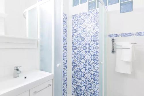 a bathroom with a shower with a blue and white pattern at Nobile Casa in Rome