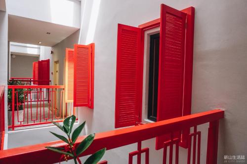 a group of red shuttered windows on a building at HOTEL CIQ, JALAN TRUS in Johor Bahru