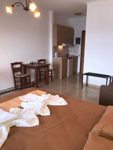 a room with a table with white towels on it at TO VOTSALO-beach side studios & taverna in Karpathos Town