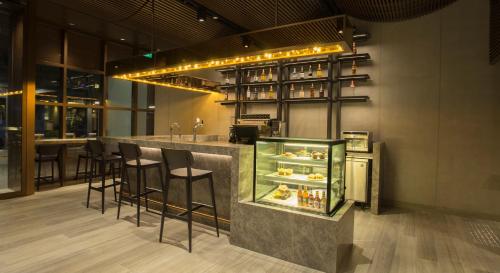 a restaurant with a bar with stools and a counter at 30 Bencoolen in Singapore
