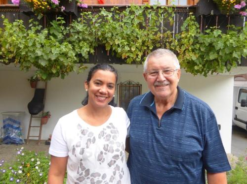 a man and a woman standing in front of a house at Chalet-Gafri - BnB - Frühstückspension und Gastfreundschaft in Wilderswil