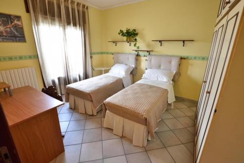 una camera con due letti di Appartamento Orchidea a Melissano