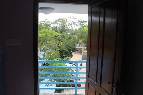 an open door with a view of a pool at Puthenchirayil Homestay in Trivandrum