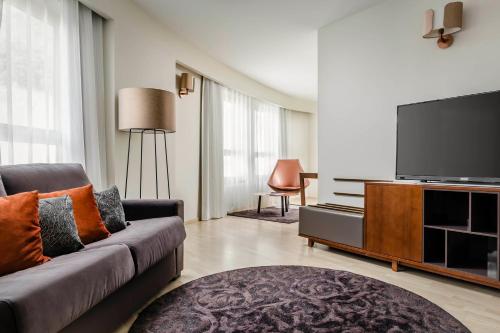 a living room filled with furniture and a tv at Eurostars Andorra in Andorra la Vella
