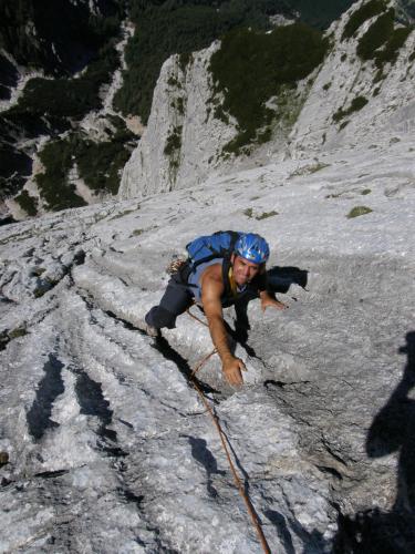a man climbing up a snow covered mountain at Atelierwohnung Jirana in Saalfelden am Steinernen Meer