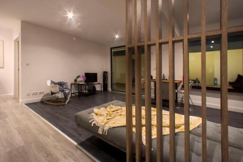a room with a bed and a desk with a chair at "Scandinavian" apartment in Cascais's old town in Cascais