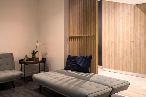 a living room with a couch and a chair at "Scandinavian" apartment in Cascais's old town in Cascais