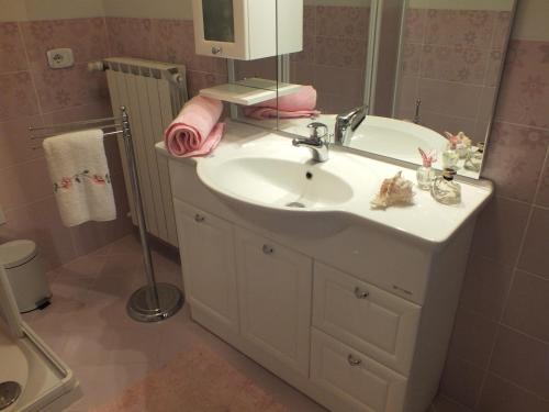 a bathroom with a white sink and a mirror at Casa Stella in Bastia Umbra