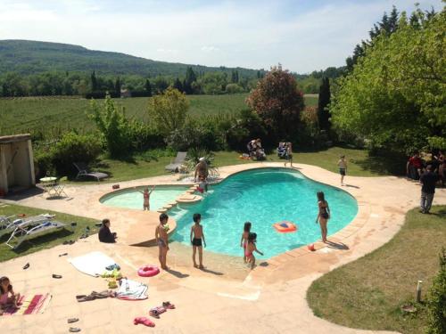 a group of people playing with frisbees in a pool at Le Mas de Valaurie in Valaurie