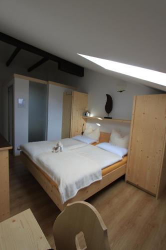 a bedroom with a large bed in a room at Gästehaus Waldrand Garni in Wiesing