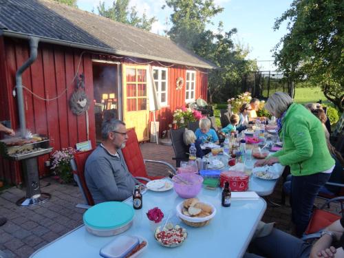 a group of people sitting around a table with food at Hansenhof in Kappeln
