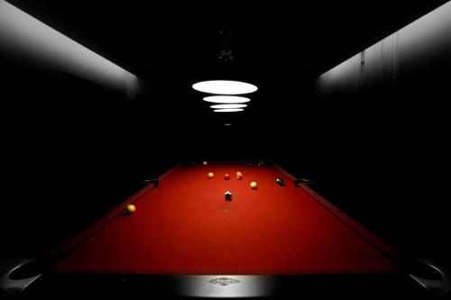a room with a red table with balls on it at Hotel-Résidence Am Klouschter in Mondorf-les-Bains