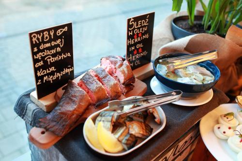 a tray of food with meat and other foods on a table at Rest Apartments in Wrocław