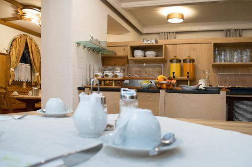 a kitchen with a table with two cups and spoons at Pension Irlingerhof in Mondsee