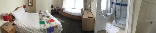 a room with two beds and a bedroom with a crib at The Swallow Hotel in Bridlington