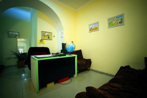 a living room with a green table and a couch at Hostel City Center in Kutaisi