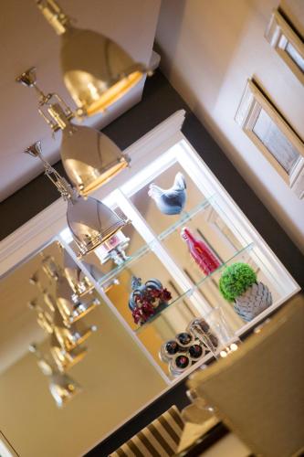 a kitchen counter with a shelf with items on it at Oleander Guest House in Kimberley