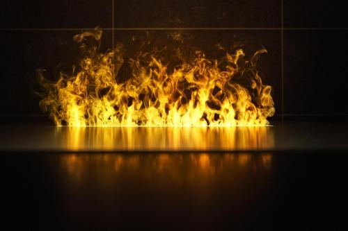 a fire burning in a fireplace with flames at Jaz in the City Stuttgart in Stuttgart