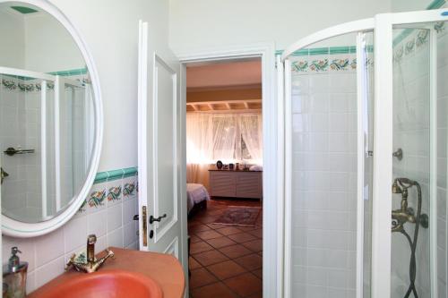 a bathroom with a shower and a sink and a mirror at Boutique Villa Andronice in Tsoukaladhes